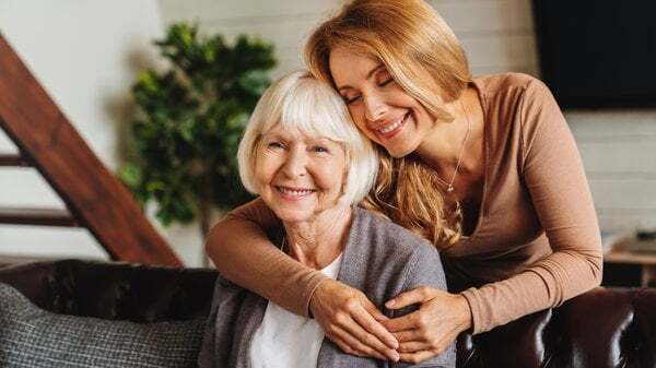 memory-care-young-woman-hugging-elderly-mother-3